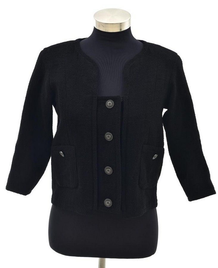 A jacket by Chanel, the cropped jacket styled in a black wool ...