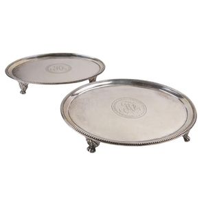 A pair of card salvers. Having an oval shape with beaded edging…
