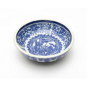 A Kakiemon blue and white bowl printed with tiger and bamboo…