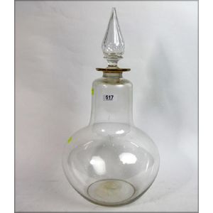 A pearl shaped glass carboy with cut glass stopper. English,…