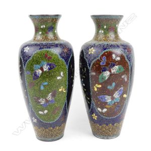 A pair of cloisonne vases, decorated in polychrome panels of…