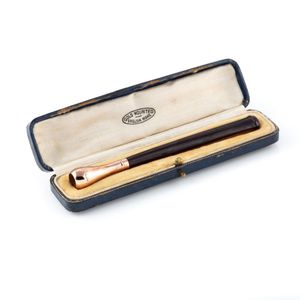 A vintage gold topped cigar holder, cherry amber colour…