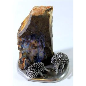 A boulder opal specimen, mounted on pewter with echidna figures