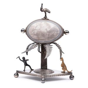An Australian carved emu egg with silver plated stand and…