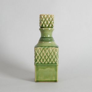 A green ceramic decanter, stylised with cut glass style…