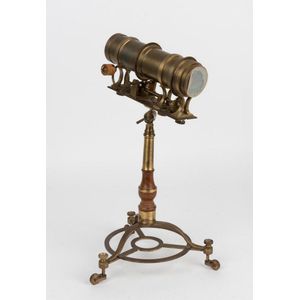 A polished brass kaleidoscope on stand, the adjustable…