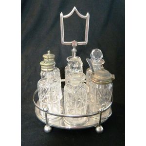 A six bottle cruet set on silver-plated stand