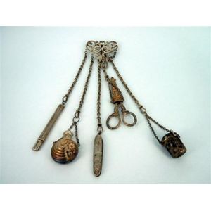 A Victorian silver chatelaine, clasp of open scrollwork design…