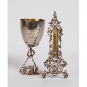 A silver plate trophy, goblet and a thermometer, 20th century,…