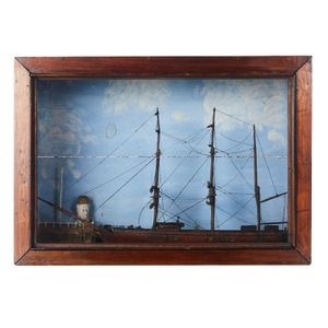 A cased model ship diorama, the clipper ship passing a headland…