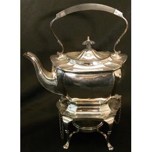 A silver-plated tea pot on stand with burner