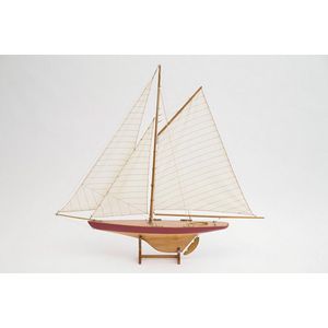 Painted wooden pond yacht on wooden stand