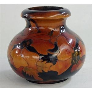 An Australian pokerwork timber vase, with floral design. Height…