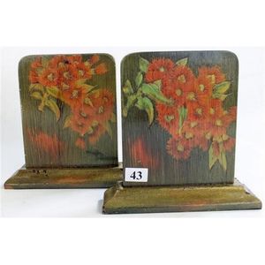 A pair of Australian pokerwork timber bookends, with bottle…