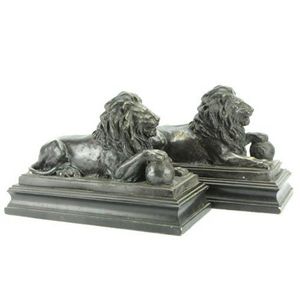 Bronze pair of lion figures modelled resting on a stepped…