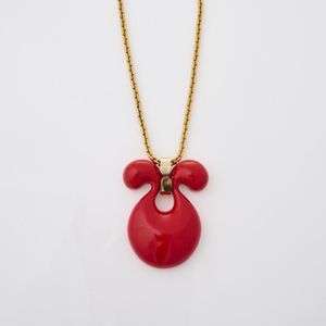 A Givenchy necklace, featuring a red resin pendant in an Omega…