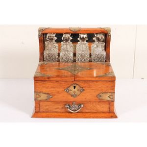 Oak tantalus cabinet, early 20th century with, four cut crystal…