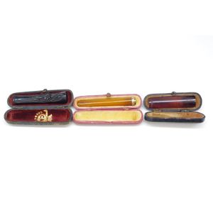 Three antique cased cheerot / cigar holder two in amber & one…