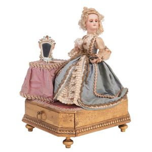 A French musical automaton of a girl at her dressing table,…