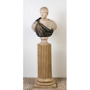 A polychrome bust of Caesar, displayed on a ribbed plinth, 86…
