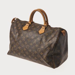 Sold at Auction: LOUIS VUITTON MONOGRAM SPEEDY BAG - France, April 1998.  Monogram canvas with leather handles and detailing. With lock, no key.  Interior flap pocket. Numbered SD0948. 8 1/2 H x