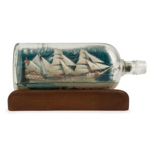 A vintage model ship in bottle, early 20th century, 29 cm long