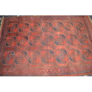 A Bokhara red wool floor rug, mid 20th century, full room size,…