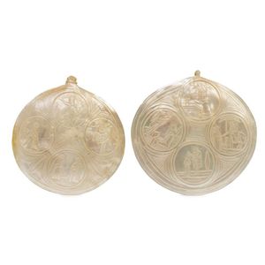 A pair of carved ecclesiastical pearl shells, depicting scenes…