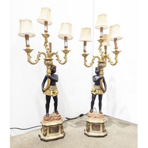 A pair of four light blackamoor table lights, each depicting a…