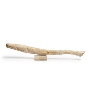 A walrus oosik (baculum) carved with whaling scene, on whale…