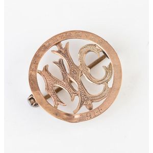 A gold prefect prize badge, central monogram 'Mlc', crafted in…