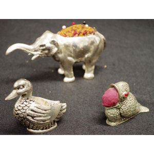 Three various vintage animal metal pin cushions comprising an…