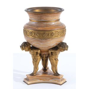 An alabaster and gilt metal vase, 19th century, supported by…