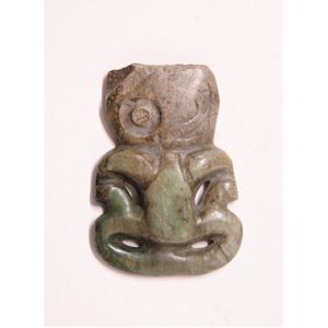 A pre-European Maori carved pounamu hei tiki, the top of the…