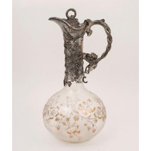 An antique English claret jug with silver plated mounts and…