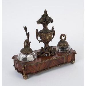 An antique French kingwood desk set with ormolu mounts and cut…