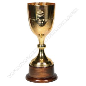 A 1968 9ct gold Auckland Trotting club cup, the round spreading…