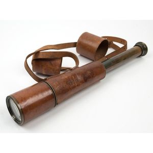 An antique English telescope with original brown leather mounts,…