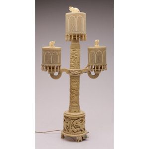 An impressive carved early ivory three branch table lamp…