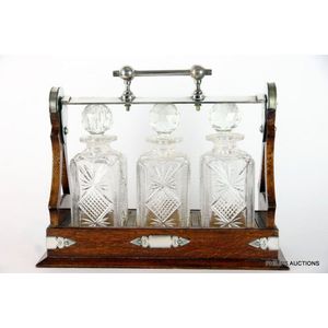 A Victorian oak and silver plate tantalus, late 19th century,…