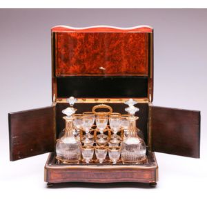 An antique flame mahogany cave a liqueur, height 27.5 cm, width…