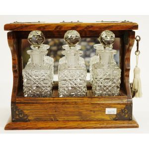 Vintage mini oak cased three decanter tantalus containing 3 cut…