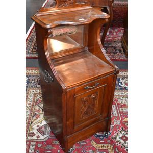 Polished mahogany coal cabinet with carved door, mirror back…