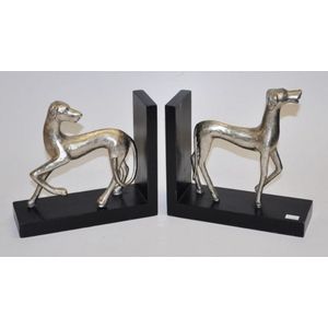 Pair of decorative cast metal dog bookends standing on timber…