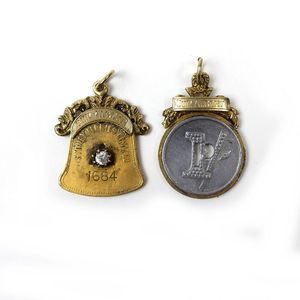 Two vintage Australian tokens/passes, one silver gilt of bell…