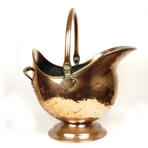 A Victorian copper helmet coal scuttle, with swing handle and…
