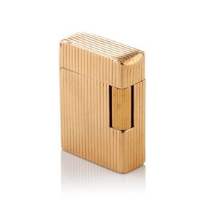 A vintage gold cigarette lighter by Dupont rectangular form,…