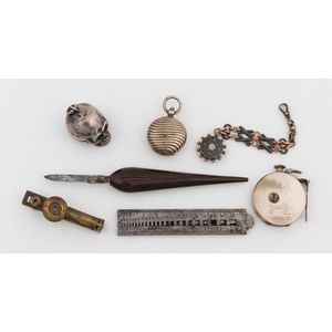 A group of eclectic accessories, comprising a watch knife, a…