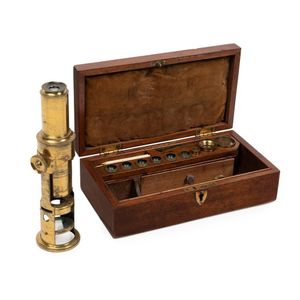 An antique brass scientists monocular field microscope,…