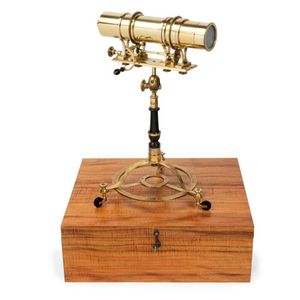 A polished brass kaleidoscope by George Gyori, in a fiddleback…